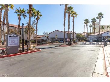 Gated community entrance with palm trees and designated parking at 2615 W Gary Ave # 1069, Las Vegas, NV 89123