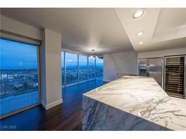 Modern kitchen with marble island and city views at 3111 Bel Air Dr # 18F, Las Vegas, NV 89109