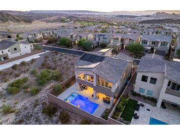 Aerial view of a luxury home with a private pool and solar panels, nestled in a beautiful community at 8 Hilltop Crest St, Henderson, NV 89011