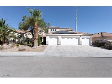 Two-story house with three-car garage, solar panels, and desert landscaping at 1306 Big Tree Ave, North Las Vegas, NV 89031