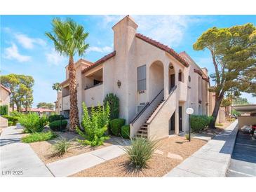 Spanish style condo building with palm trees and landscaping at 1751 E Reno Ave # 206, Las Vegas, NV 89119