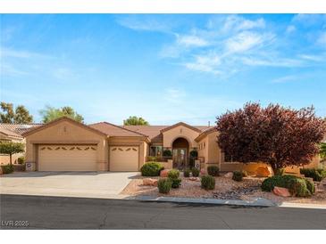 Single-story house with three-car garage,landscaped front yard, and neutral color scheme at 2563 Collinsville Dr, Henderson, NV 89052