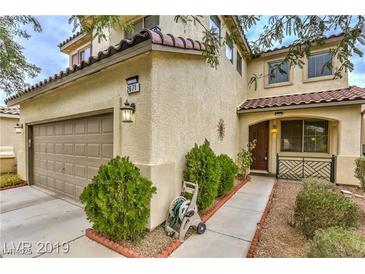 Inviting two-story home with a landscaped front yard and two-car garage at 2671 Colina Bella Ct, Las Vegas, NV 89142