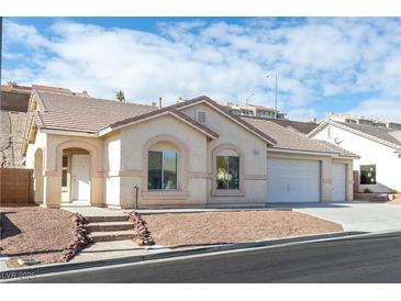 Single-story house with a two-car garage and landscaped yard at 2915 Rippling Springs St, Laughlin, NV 89029