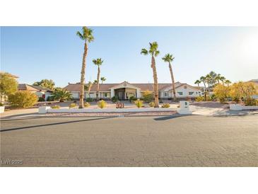 Single story home with desert landscaping and palm trees in front yard at 321 E Middleton Dr, Henderson, NV 89015
