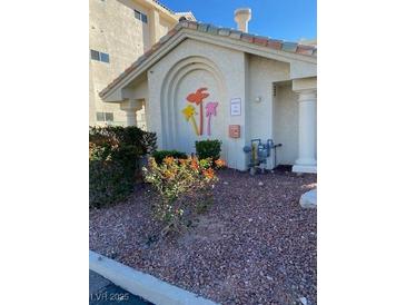 Property entrance with colorful palm tree decorations and manicured landscaping at 3550 Bay Sands Dr # 3081, Laughlin, NV 89029
