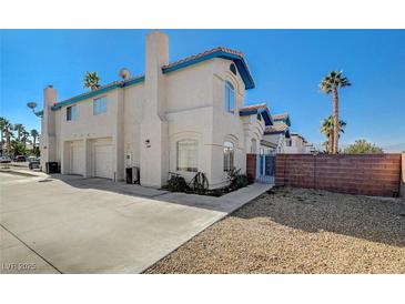 Two-story house with attached garage and landscaped yard at 5040 Sublight Ave, Las Vegas, NV 89108