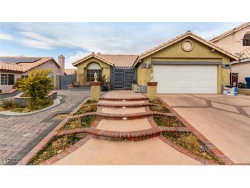 Single-story house with a two-car garage and landscaped walkway at 6442 Cedar Breaks Ave, Las Vegas, NV 89156