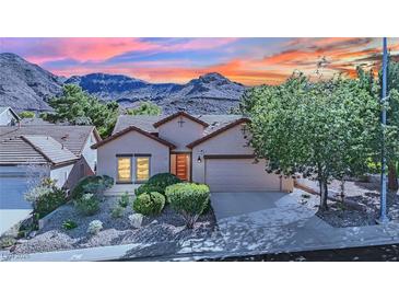 Charming single-story home featuring well-maintained landscaping and stunning mountain views at 725 Pacific Cascades Dr, Henderson, NV 89012