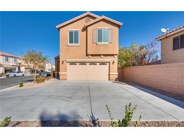 Inviting two-story home featuring a spacious driveway and attached two-car garage at 8736 Summoners Ct, Las Vegas, NV 89139