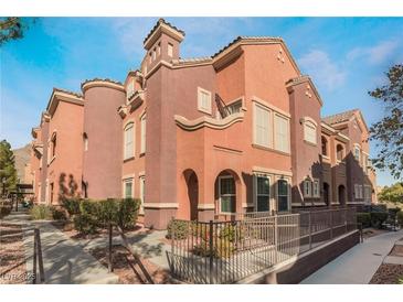 Spanish-style townhome with a two-story elevation, featuring a modern color scheme and landscaping at 3975 N Hualapai Way # 266, Las Vegas, NV 89129