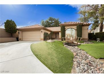 Charming home with beautiful landscaping, decorative bridge and well-manicured front yard at 4401 Inez Dr, Las Vegas, NV 89130