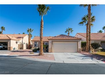 Single-story house with a two-car garage and desert landscaping at 5524 Desert Valley Dr, Las Vegas, NV 89149