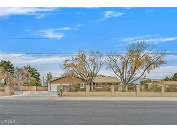Single story home with landscaped yard and gated entrance at 7390 W Rome Blvd, Las Vegas, NV 89131