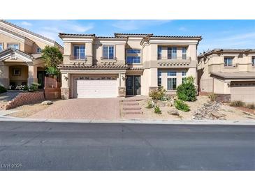 Two-story house with a three-car garage and landscaping at 9472 Ojibwa Ave, Las Vegas, NV 89149