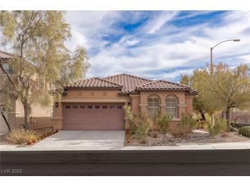 Inviting single-story home with tile roof, desert landscaping, and a two car garage at 11106 Cherokee Landing St, Las Vegas, NV 89179