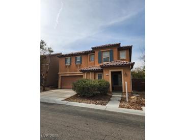 Two-story house with attached garage and landscaping at 11185 Saddle Iron St, Las Vegas, NV 89179