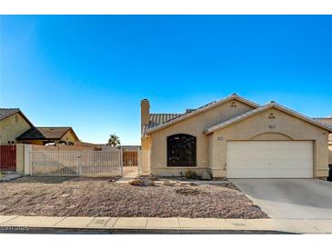 Single-story stucco home with a well-kept yard and a two-car garage, under a clear blue sky at 2177 Bridle Wreath Ln, Las Vegas, NV 89156