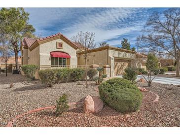 Charming single-story home with stucco siding, tile roof, and desert landscaping at 2520 Palmridge Dr, Las Vegas, NV 89134