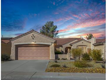 Single-story house with a two-car garage and desert landscaping at 2612 Harrisburg Ave, Henderson, NV 89052