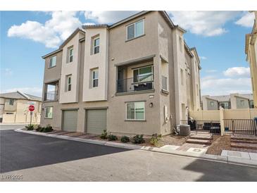 Three-story townhome with two-car garage, private patio, and neutral color palette at 2669 Champagne Gold Ave, North Las Vegas, NV 89086