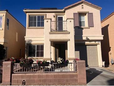 Two-story house with balcony, landscaped yard, and attached garage at 3679 Wild Springs St, Las Vegas, NV 89129