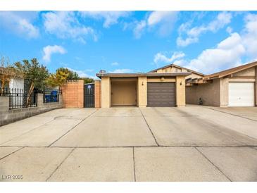 Front view of a single-story home with a two-car garage and a paved driveway at 4642 Via San Rafael, Las Vegas, NV 89103