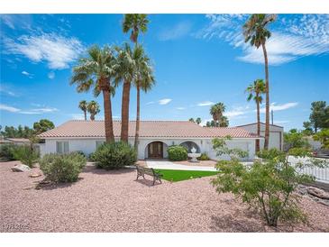 Single story home with landscaped yard, fountain, and palm trees at 5515 Coley Ave, Las Vegas, NV 89146