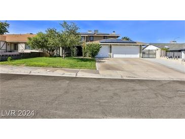 House exterior featuring a two-car garage and well-maintained lawn at 722 Barrie Ct, Henderson, NV 89002