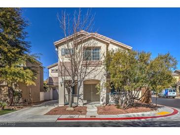 Two-story house with attached garage and landscaping at 9178 Sunken Meadow Ave, Las Vegas, NV 89178