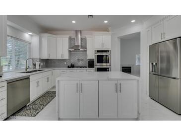 Bright kitchen features stainless steel appliances, marble countertops, and a center island at 2604 Sun Reef Rd, Las Vegas, NV 89128