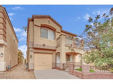 Two-story house with attached garage and balcony at 10424 Wyatt Earp Ct, Las Vegas, NV 89129