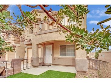 Charming two-story home featuring a covered porch and small balcony with decorative railing at 10424 Wyatt Earp Ct, Las Vegas, NV 89129