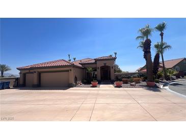 Single-story house with a two-car garage and desert landscaping at 10470 W Ann Rd Rd, Las Vegas, NV 89149