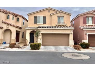 Two-story house with tan exterior, two-car garage, and landscaping at 10636 Tulip Valley Rd, Las Vegas, NV 89179