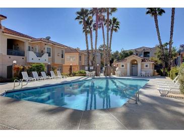 Community pool with lounge chairs and patio area at 114 Harbor View Dr # 1025, Boulder City, NV 89005