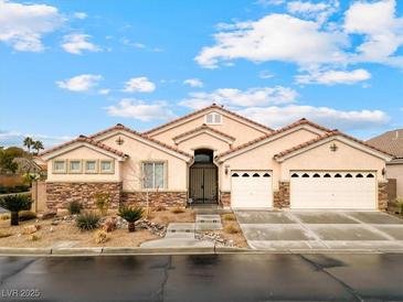 Charming single story home with desert landscaping, a red tile roof and attached two car garage at 2026 Dakota Lodge Ave, Las Vegas, NV 89123