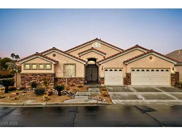 Charming single-story home with a gated courtyard, desert landscaping, and a two-car garage at 2026 Dakota Lodge Ave, Las Vegas, NV 89123