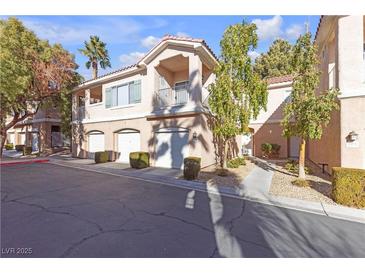 Charming condo exterior showcasing garage, balcony, and well-maintained landscaping at 251 S Green Valley Pkwy # 1212, Henderson, NV 89012