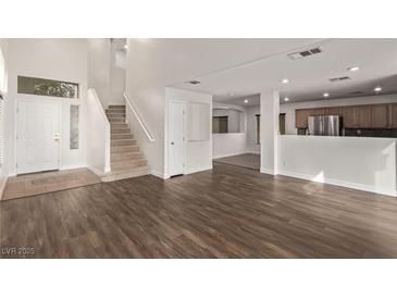 Bright entryway with tile flooring, staircase, and access to the main living areas at 2730 Morning Break Ct, Las Vegas, NV 89142