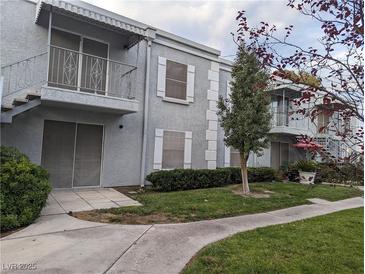 Two-story condo featuring balconies, neutral stucco, white trim, and stairs to upper unit at 3823 S Maryland Pkwy # C3, Las Vegas, NV 89119