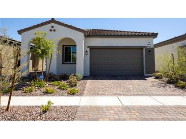 Single-story home with a two-car garage and well-manicured landscaping at 862 Silverton Springs St, Henderson, NV 89011