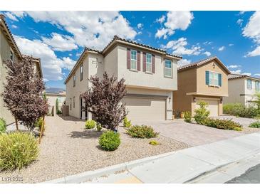 Two-story house with beige siding, brown shutters, and a paved driveway at 9332 Newbattle St, Las Vegas, NV 89178