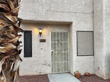 Neat townhouse exterior with security door and landscaping at 2611 Aracatuba Ave, Las Vegas, NV 89121