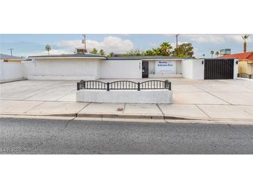 Wide shot of an Absolute Palliative Care building's exterior with ample parking space at 3127 S Eastern Ave, Las Vegas, NV 89169