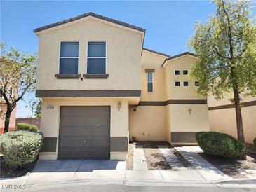 Two-story house with attached garage and landscaping at 6104 Daisy Lee Ave, Las Vegas, NV 89108