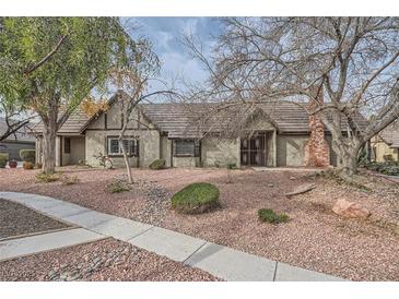Single-story house with a brown roof and landscaped yard at 3954 Edgemoor Way, Las Vegas, NV 89121