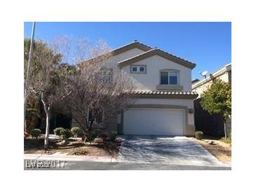 Two-story house with attached garage and landscaping at 6687 Keyesport Ct, Las Vegas, NV 89148