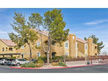 Tan two-story building with trees, parking, and gated entrance at 7950 W Flamingo Rd # 1054, Las Vegas, NV 89147