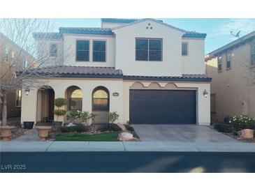 Two-story house with a gray door and landscaping at 927 Via Canale Dr, Henderson, NV 89011
